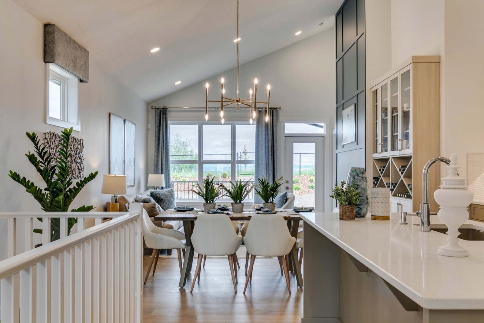 a dining room and kitchen with a table and chairs